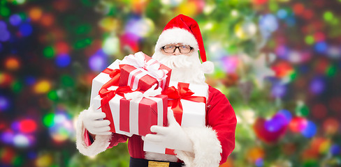 Image showing man in costume of santa claus with gift boxes