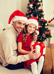 Image showing smiling father and daughter holding gift box