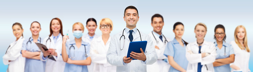 Image showing group of doctors with tablet pc and clipboard