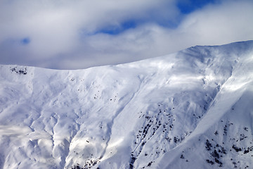 Image showing Off-piste slope at evening and sky with clouds