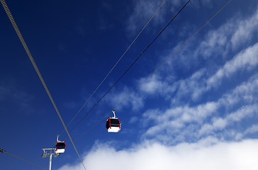 Image showing Gondola lifts at ski resort and blue sky with clouds in nice day