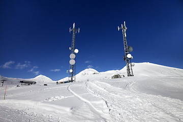 Image showing Ratrac ski road and satellite dishes at nice sun day