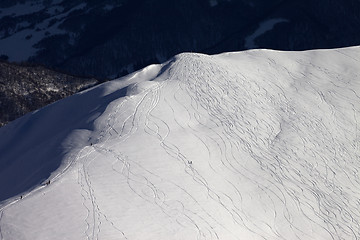 Image showing Top view on off piste slope with snowboarders and skiers at even