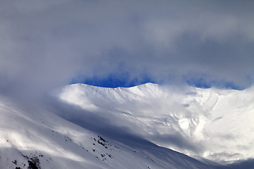 Image showing View on sunlight off-piste slope in mist