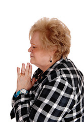 Image showing Praying senior woman in profile.