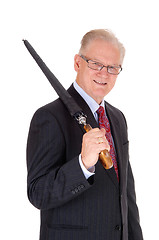 Image showing Senior man with umbrella over shoulder.