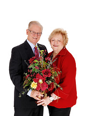 Image showing Closeup of senior couple with flowers.