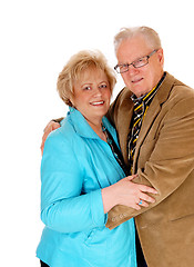 Image showing Senior couple standing and hugging.
