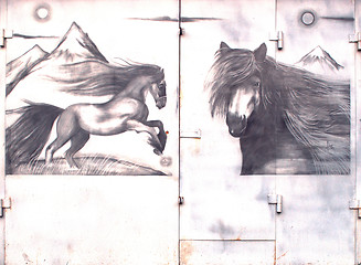 Image showing iron gate with pictures of horses