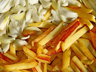 Image showing Fried potato chips and cutting onions