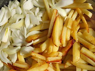 Image showing Potato chips and cutting onions