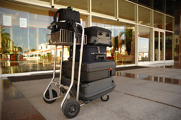 Image showing Trolley with suitcases in front of hotel