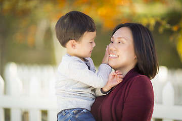 Image showing Chinese Mom Having Fun and Holding Her Mixed Race Boy