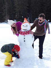 Image showing happy family making snowman