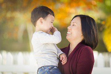 Image showing Chinese Mom Having Fun and Holding Her Mixed Race Boy