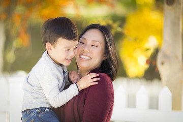 Image showing Chinese Mom Having Fun and Holding Her Mixed Race Boy