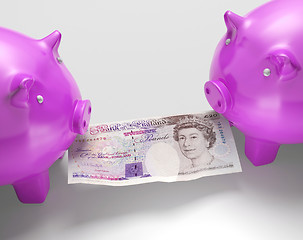 Image showing Piggybanks Fighting Over Money Showing Savings