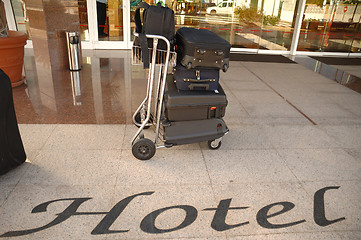 Image showing Suitcases and trolley in front of hotel