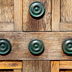 Image showing in london antique brown door  rusty  brass nail and light