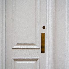 Image showing handle in london antique brown door  rusty  brass nail and light