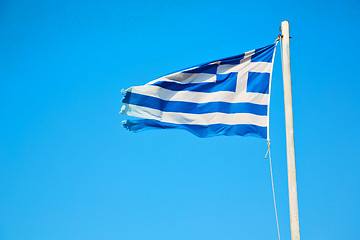 Image showing waving in the blue sky and flagpole