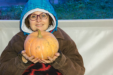 Image showing A woman with a pumpkin  