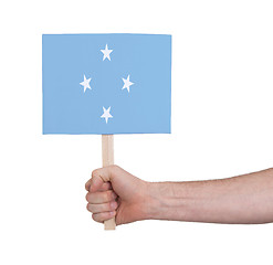 Image showing Hand holding small card - Flag of Micronesia