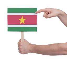 Image showing Hand holding small card - Flag of Suriname