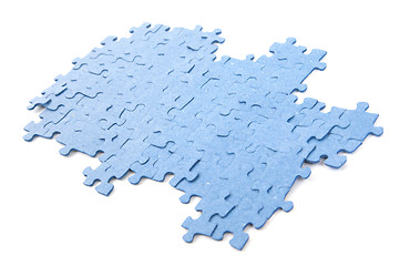 Image showing Connected blue puzzle pieces isolated