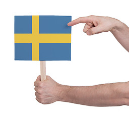 Image showing Hand holding small card - Flag of Sweden