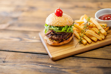 Image showing Home made burgers on wooden background