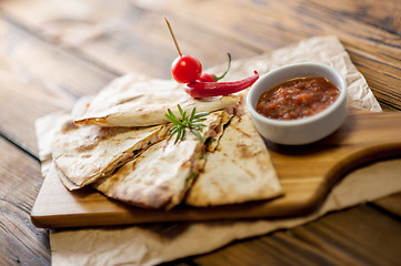 Image showing Tacos on wooden background with sauce