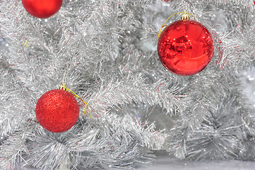 Image showing Red baubles on silver artificial christmas tree