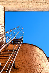 Image showing Industrial ladder, blue sky and brick walls of the building