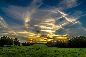 Image showing sunset over green field farm land