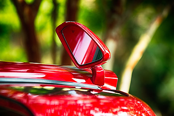 Image showing open door and side view mirror of exotic luxury car