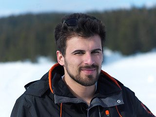 Image showing portrait of young man with beard and sunglasses on fresh snow