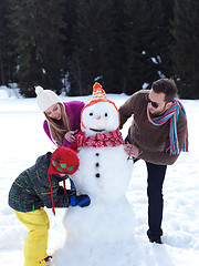 Image showing happy family making snowman