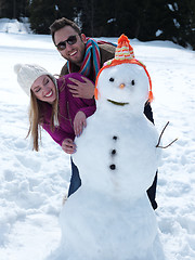 Image showing portrait of happy young couple with snowman