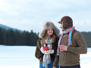 Image showing happy young couple drink warm tea at winter