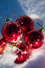 Image showing red christmas ball in fresh snow