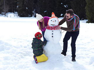 Image showing happy family making snowman