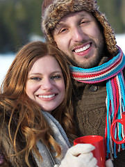 Image showing happy young couple drink warm tea at winter
