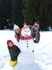 Image showing happy family making snowman