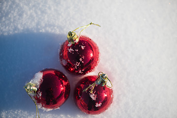 Image showing red christmas ball in fresh snow