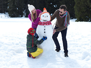 Image showing happy family making snowman