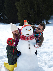 Image showing happy family making snowman