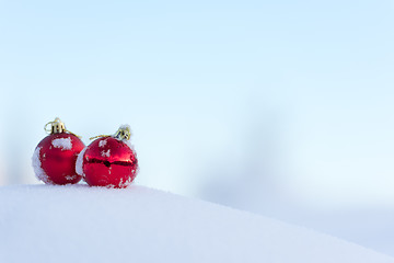 Image showing red christmas balls in fresh snow