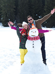 Image showing happy family making snowman