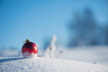 Image showing red christmas ball in fresh snow